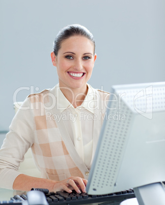 Positive businesswoman working at a computer