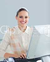 Positive businesswoman working at a computer