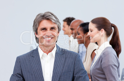 Smiling manager in front of his team