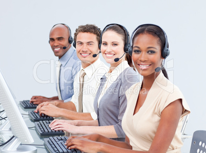 Multi-ethnic customer service representatives using headset