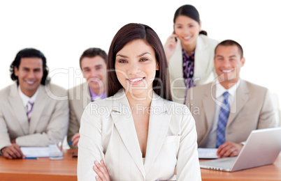 Assertive businesswoman with her team in the background