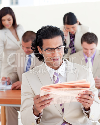 Self-assured manager reading a newspaper