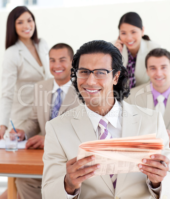 Cheerful manager reading a newspaper