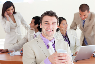 Cheerful manager drinking a coffee