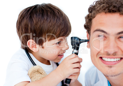 Cute little boy playing with his doctor