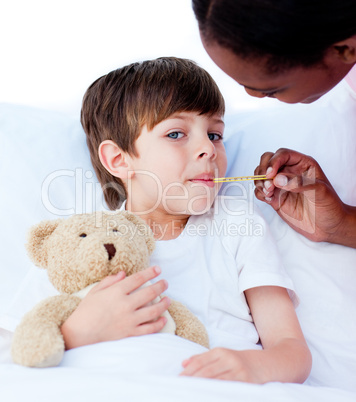 Serious nurse taking child's temperature