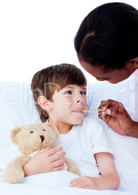 Female nurse taking child's temperature