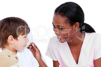 Smiling doctor taking child's temperature