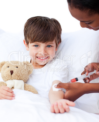 Smiling little boy receiving an injection