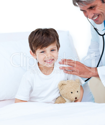 Smiling doctor checking little boy's pulse