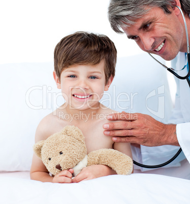 Mature doctor checking little boy's pulse