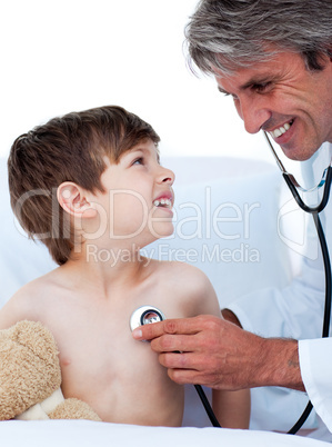 Mature male doctor checking little boy's pulse