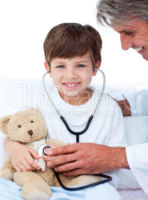 Adorable Little boy playing with his doctor