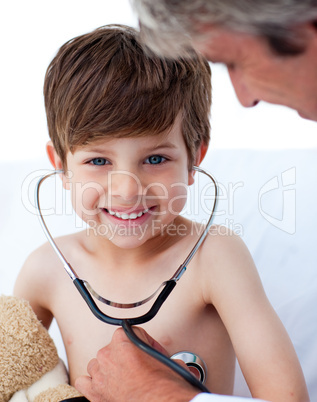 Attentive doctor playing with a little boy