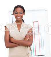 Smiling female executive reporting sales figures