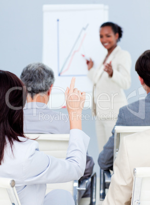 Young businesswoman asking a question at a conference