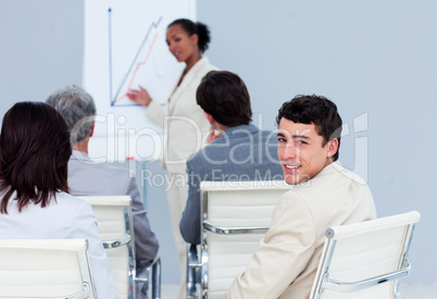 Young businessman looking at the camera at a conference