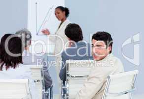 Young businessman looking at the camera at a conference