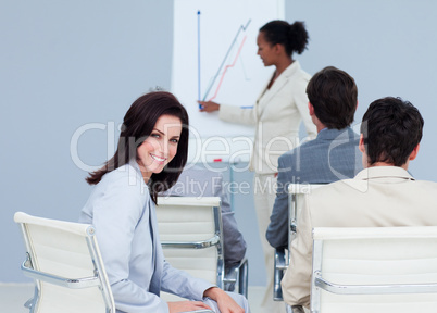 Attractive businesswoman smiling at the camera at a conference