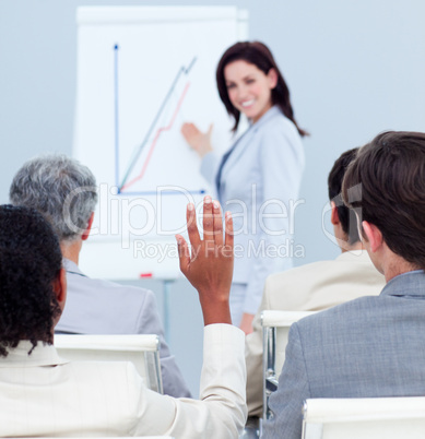 Concentrated businesswoman asking a question at a conference