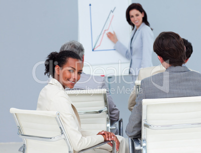 Charming businesswoman smiling at the camera at a conference