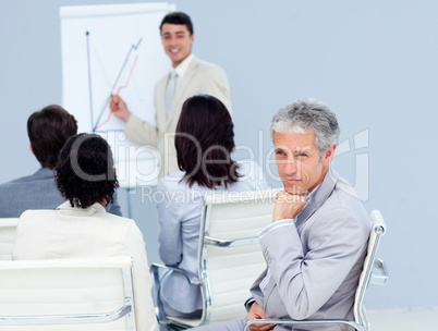 Charming businessman looking at the camera at a conference