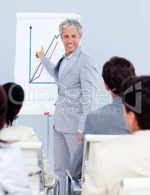Positive mature businessman doing a presentation