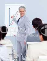 Positive mature businessman doing a presentation