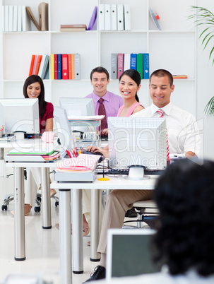 Smiling business people working at computers