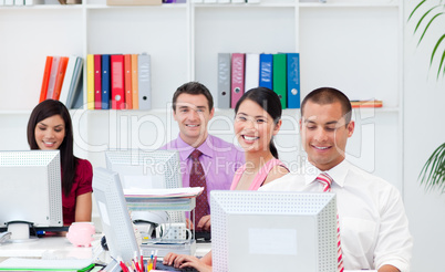 Positive business people working at computers