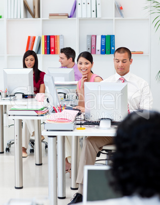 Multi-ethnic business people working at computers