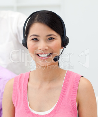 Charming young businesswoman talking on headset