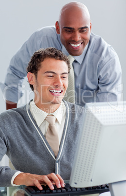 Positive business partners working at a computer