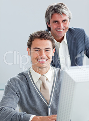 Confident business partners working at a computer