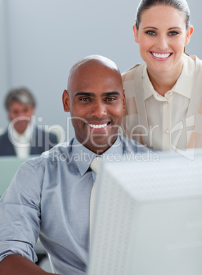Assertive business partners working at a computer together