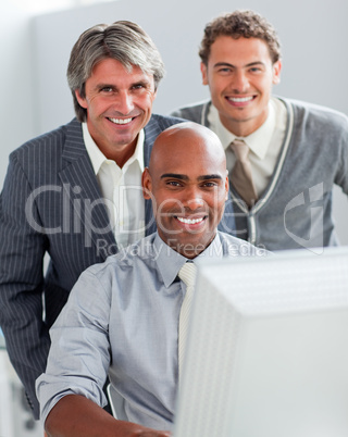 Self-assured business partners working at a computer together