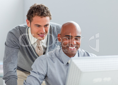 Charismatic business partners working at a computer together
