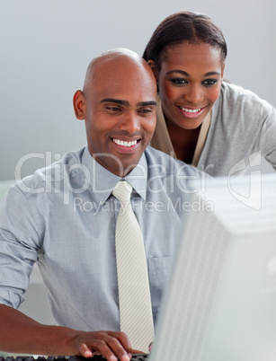 Confident business partners working at a computer together