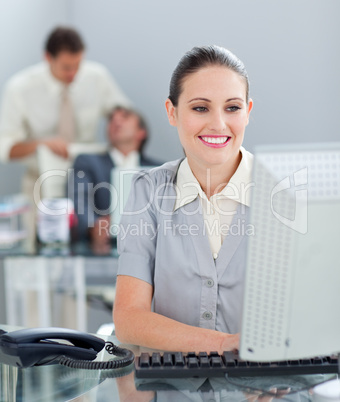 Radiant businesswoman working at a computer