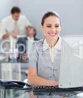 Radiant businesswoman working at a computer