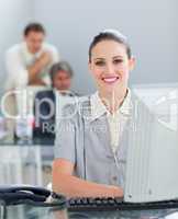 Charming businesswoman working at a computer