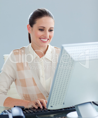 Delighted businesswoman working at a computer