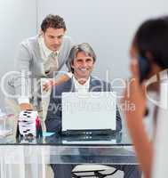 Charismatic businessmen working at a computer together