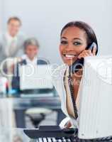 Beautiful businesswoman on phone at her desk