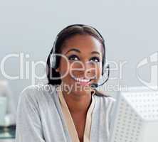 Delighted businesswoman using headset at her desk