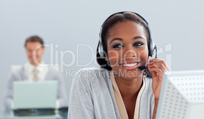 Radiant businesswoman using headset at her desk
