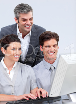 Enthusiastic business team working at a computer Enthusiastic business team working at a computer