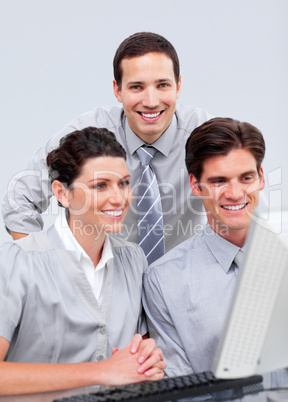Positive businessteam working at a computer