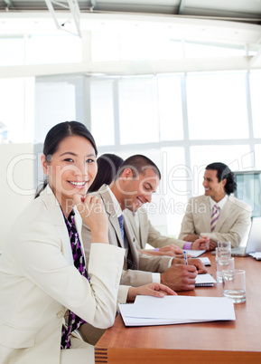 Portrait of a Asian businesswoman and her team during a presenta