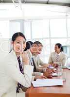 Portrait of a Asian businesswoman and her team during a presenta